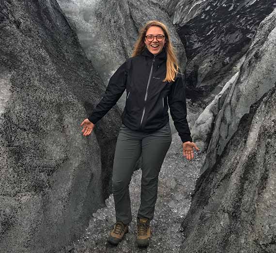 Laura Marck poses in front of a rock