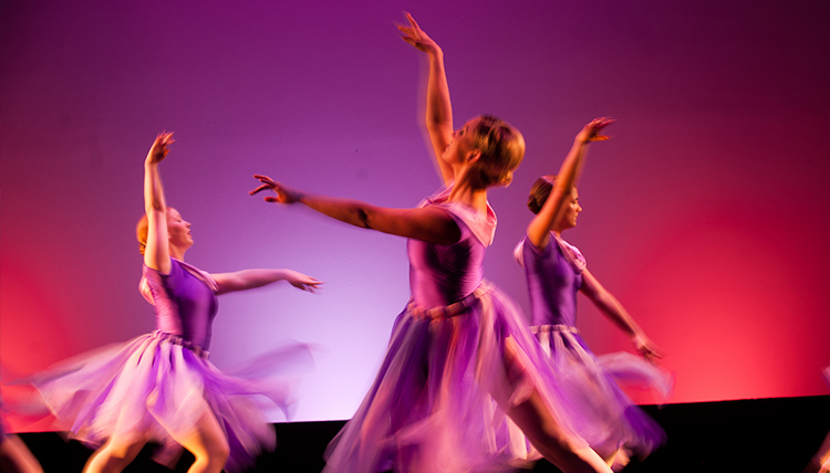 Girls performing ballet on stage.