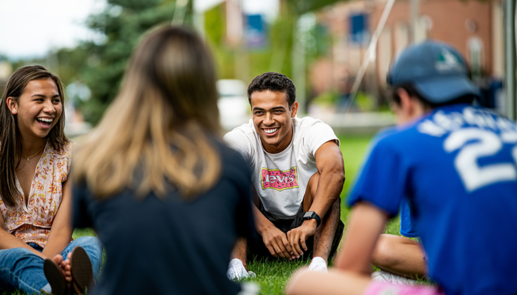 Students in a circle on a lawn