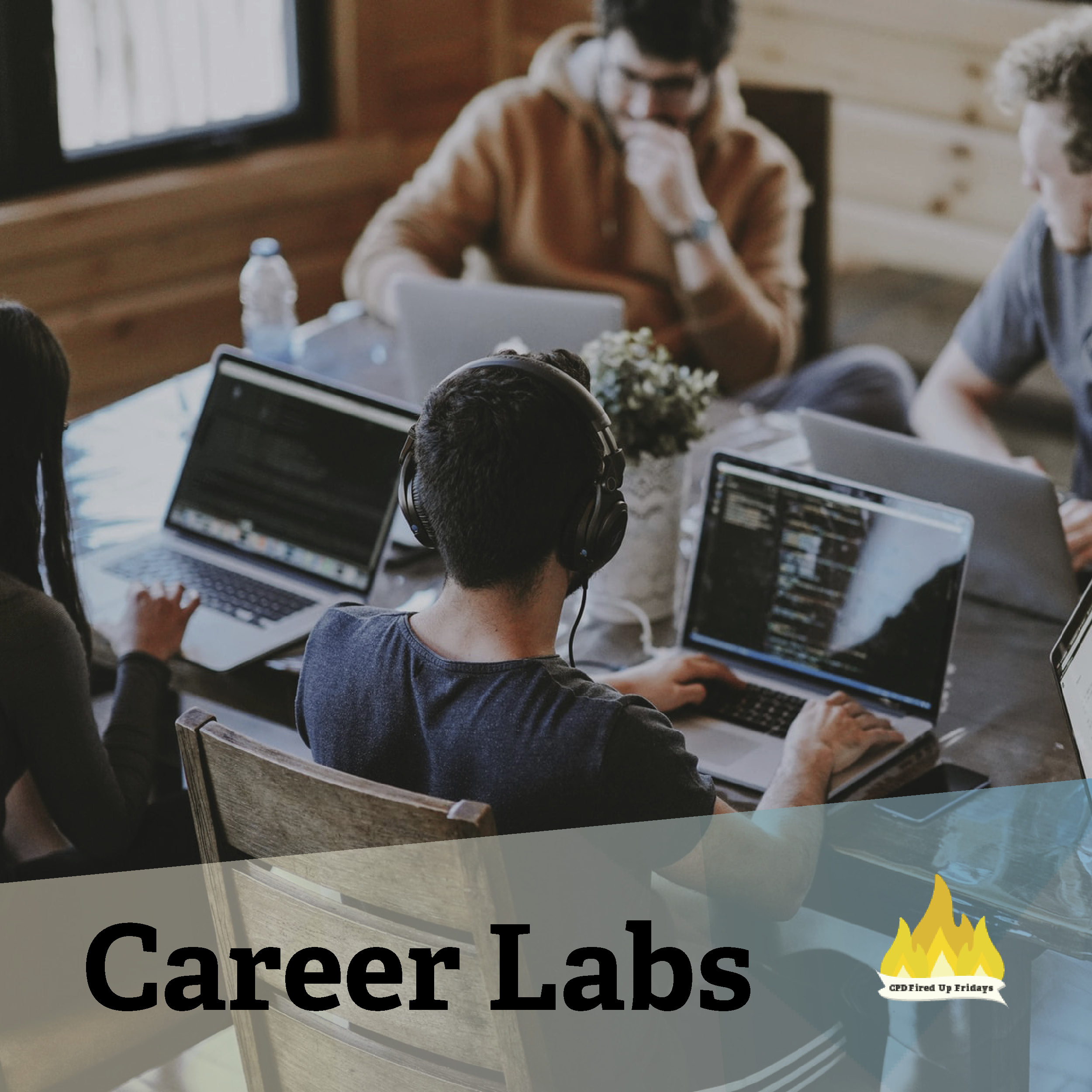 Four students sit around a table, each with a laptop open in front of them. One wears headphones, and the student in the upper right turns to the student next to him to say something. The other three are focused on their computer work. Underneath, text reads: 'Career Labs'.