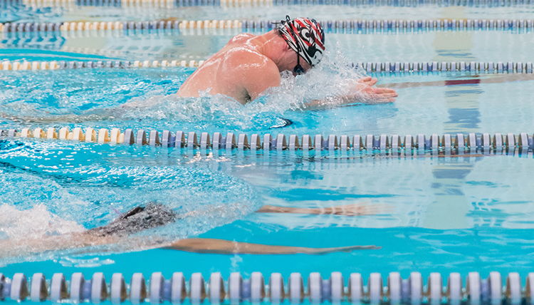 GU male student swims laps in the RFC pool