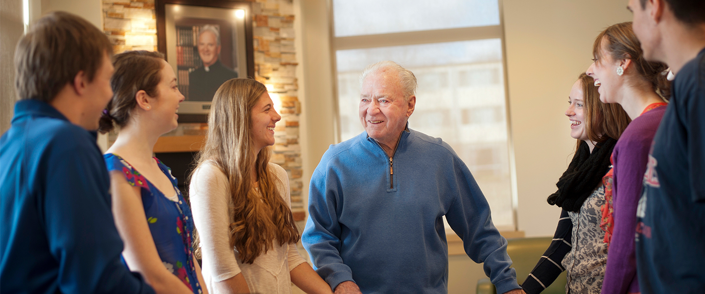 Father Coughlin Praying with Students