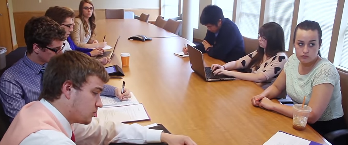 Students gathered around the table learning