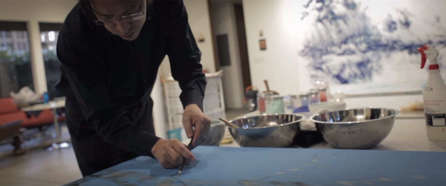 Artist Mako Fujumura painting on canvas.