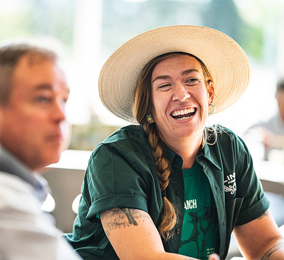 woman in hat laughing