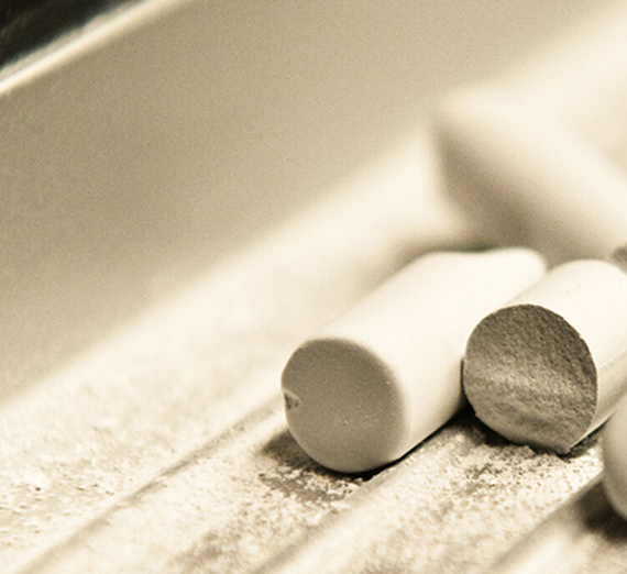 Closeup of blackboard chaulk on a tray.