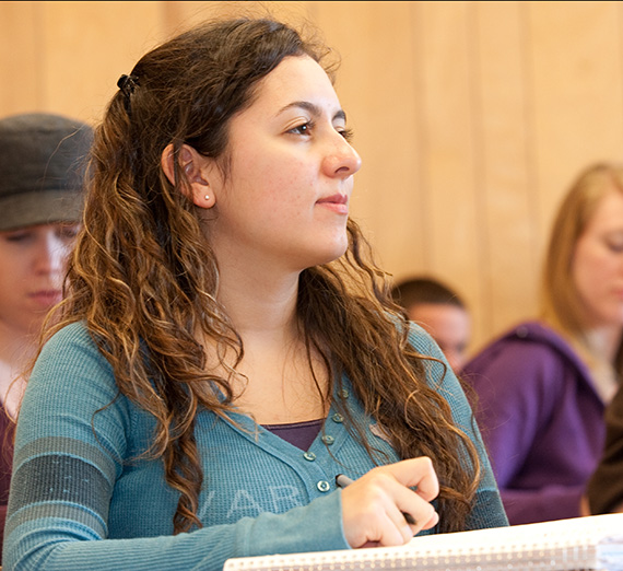 Student in class taking notes.