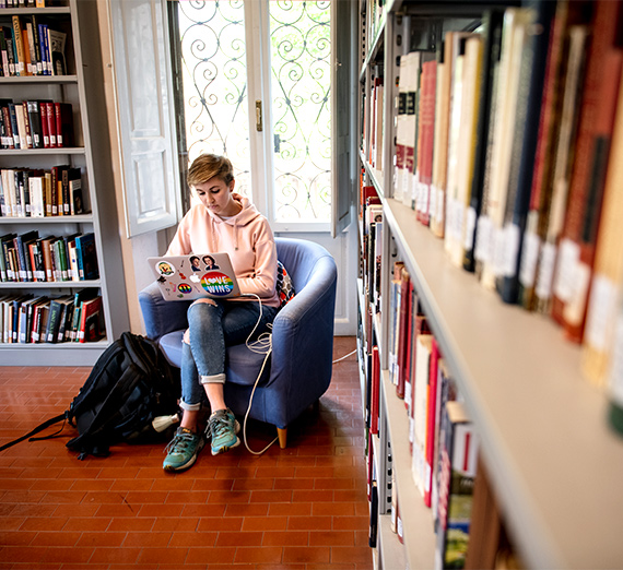 student on computer in library