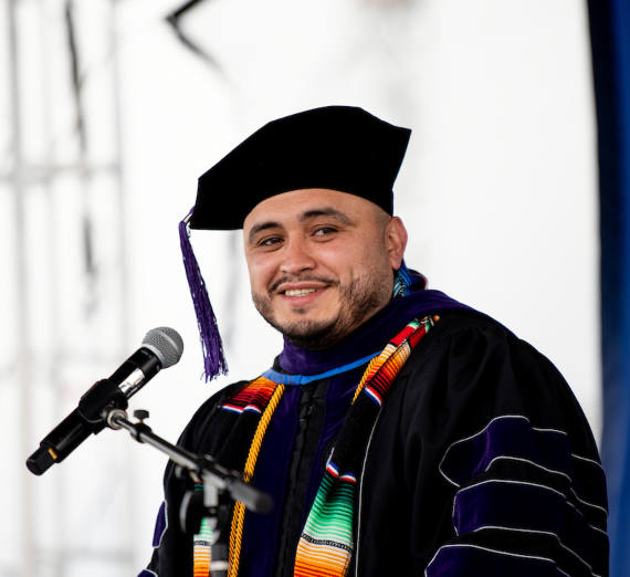 Portrait of Law School graduate Hisrael Carranza speaking at commencement