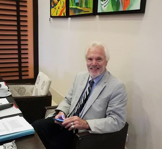 Professor Emeritus George Critchlow at a desk