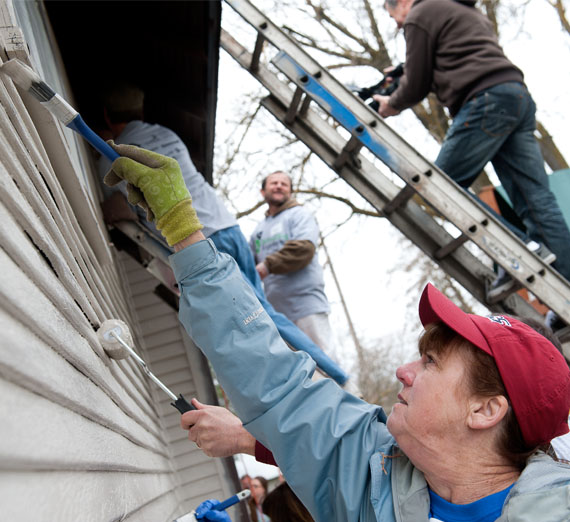 alumni painting house during service project 