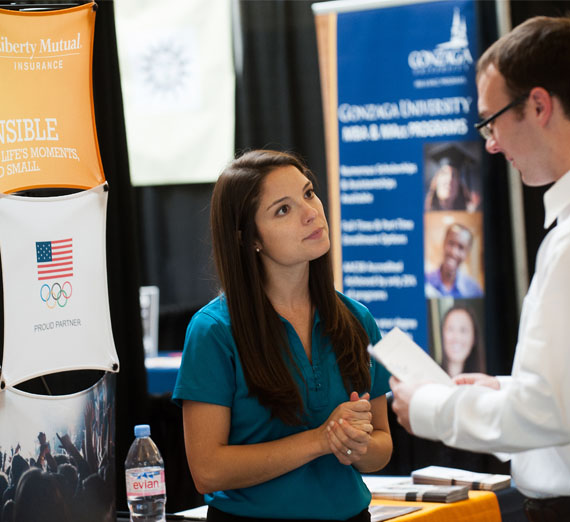student talking to employer at career fair 