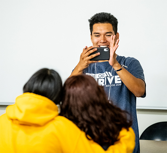 student taking photo of others