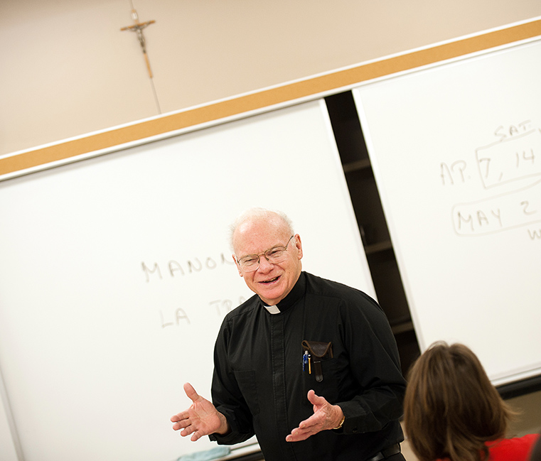 Father Waters in classroom.