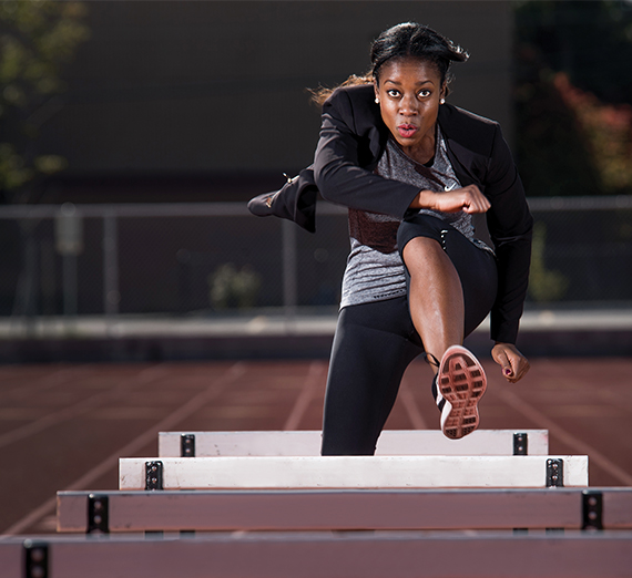 Felisha Ankton mid-hurdle.