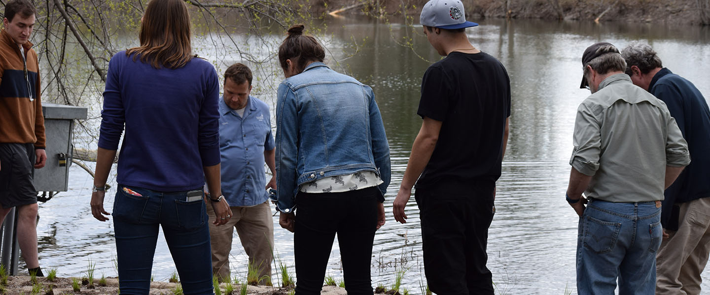 Students setting up a floating wetland in Lake Arthur