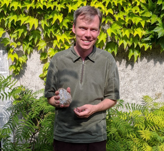 Dr. Orcutt holding a rock 