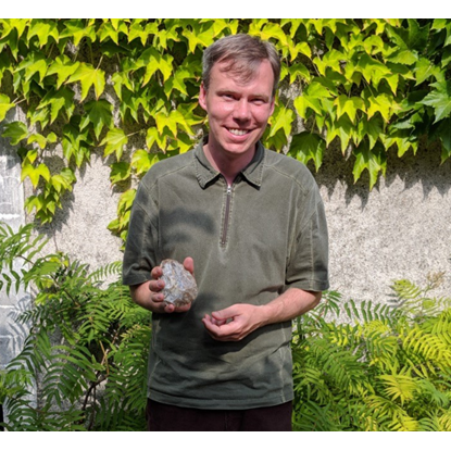 Dr. Orcutt holding a rock 