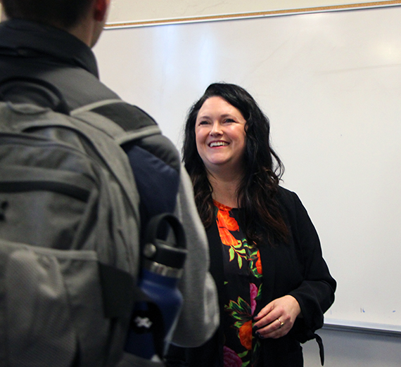 A student speaks with a professor.