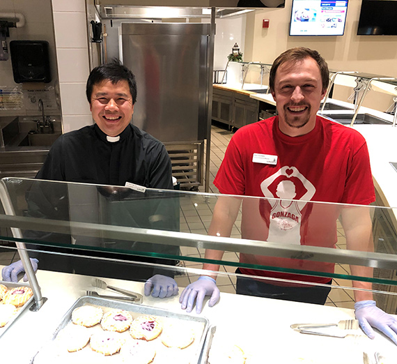Father Main, S.J. and Ben Goodwin work in the kitchens