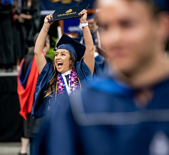 student celebrating at graduation