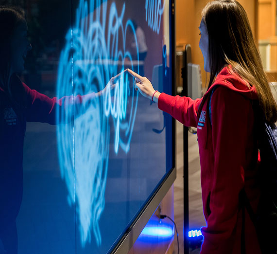 Female writing on a digital wall
