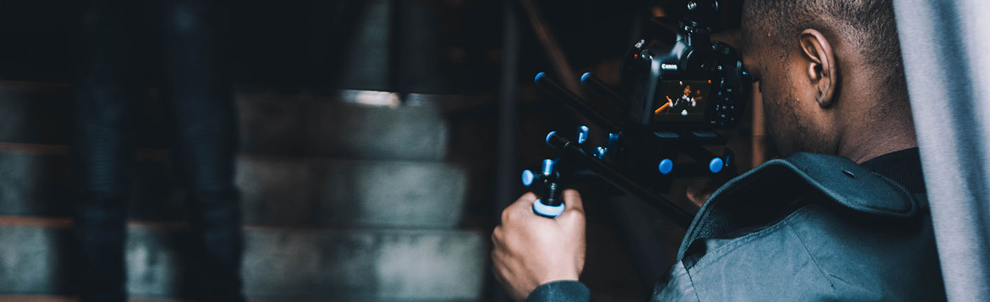 Decorative image of person recording video. 