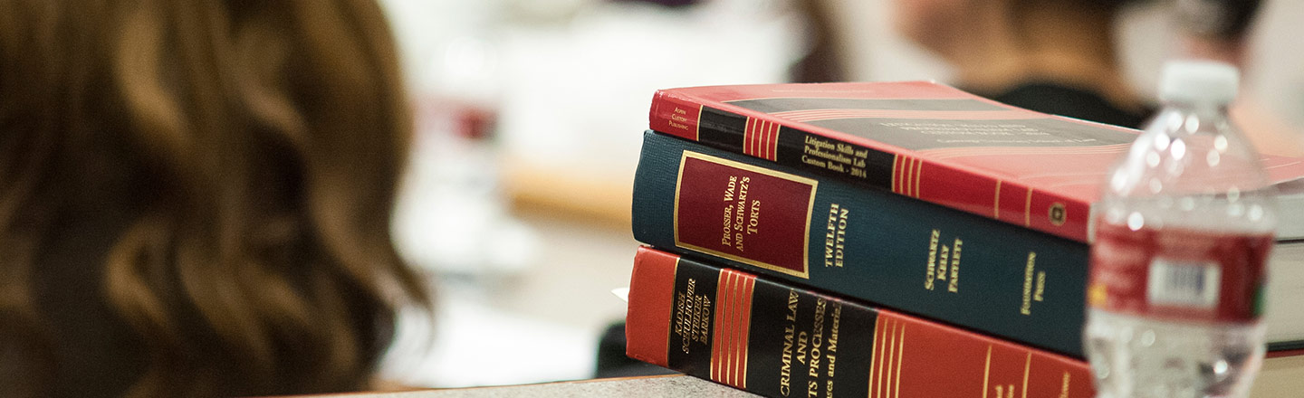 Stacked books and a water bottle