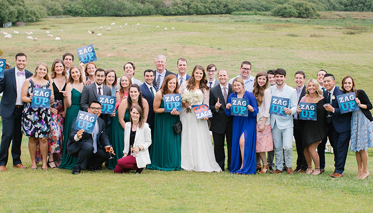 couple surrounded by lots of friends and Zag Up signs