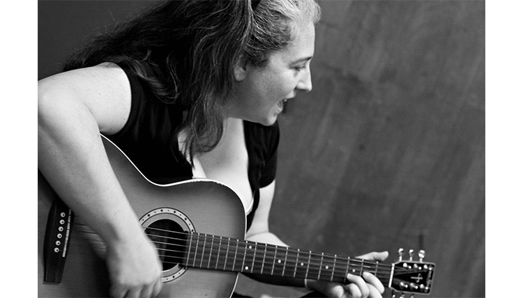 Gonzaga alumae plays guitar and sings