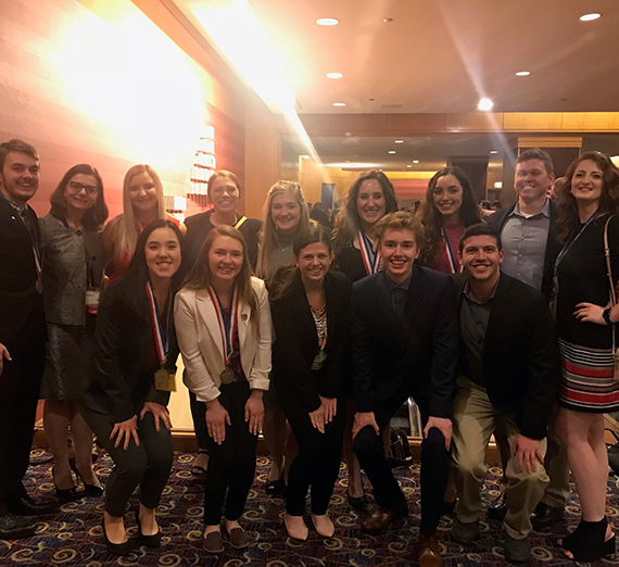 The DECA students and faculty. GU photo.