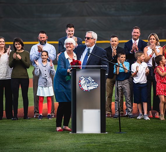 Vicki and Steve Hertz with family in the background at the Coach Steve Hertz Field dedication May 11. GU photo