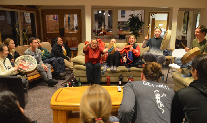 members of the Makah Tribe drum with Gonzaga students