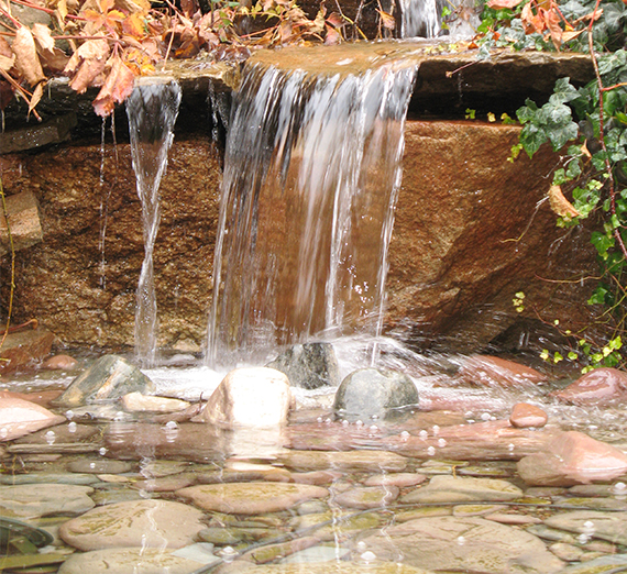 Water running on rocks with fall colors