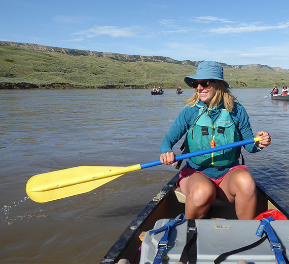 Student paddling canoe on the Missouri River