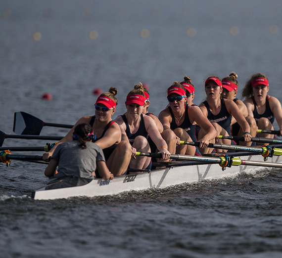 The women's crew team paddles an 8-woman boat in the NCAA Championships. 