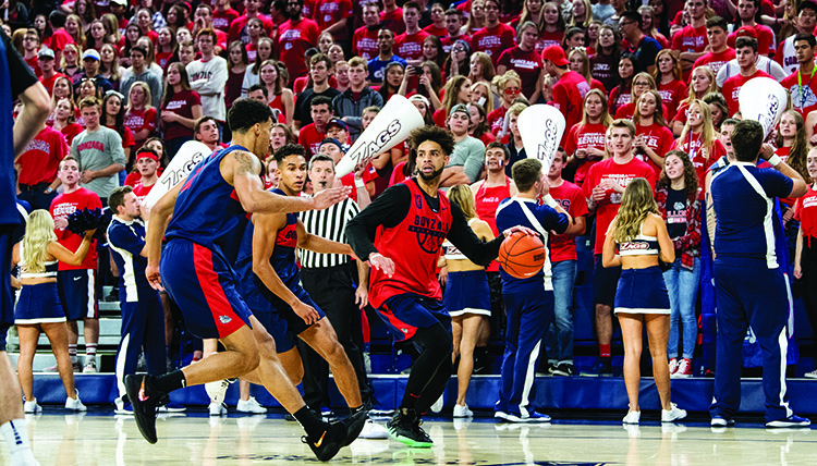 Two players compete for the ball during a basketball scrimmage. 