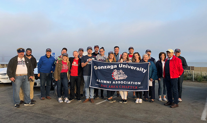 All the participants of the Gonzaga Grand Prix pose with an alumni flag. 