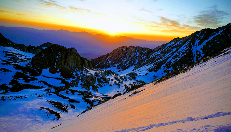 sunrise from the mountaintop with bright oranges and blues