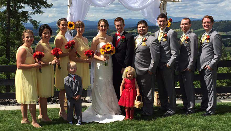 wedding party with women in yellow dresses and men in gray suits
