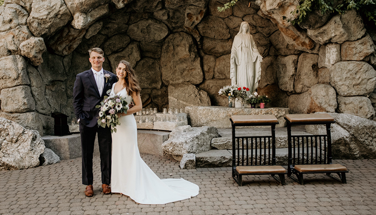 couple posed in front of GU grotto
