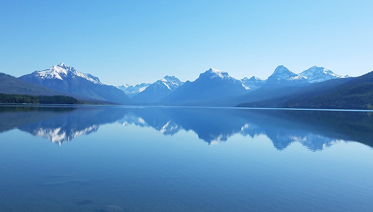 reflection of mountains on Lake McDonald in Montana