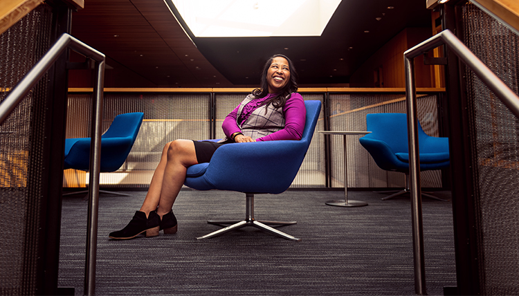 woman sits and smiles