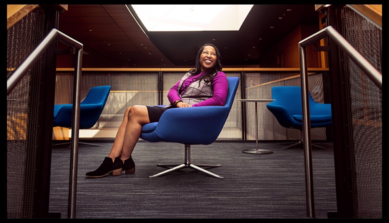 woman sits and smiles