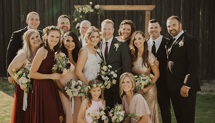groom and bride with wedding party outdoors