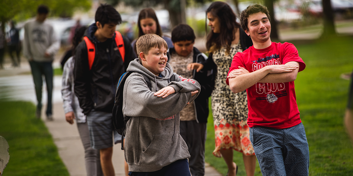 Ben Ranghiasci (’20) walking with his mentee during Campus Kids. (GU photo)