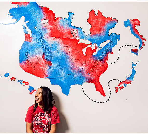 Cat Truong (’14) in front of the mural she created in Gonzaga's advancement office. (Photo by Zack Berlat)