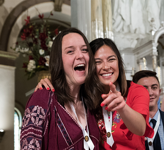 two smiling young women at a nurses pinning ceremony