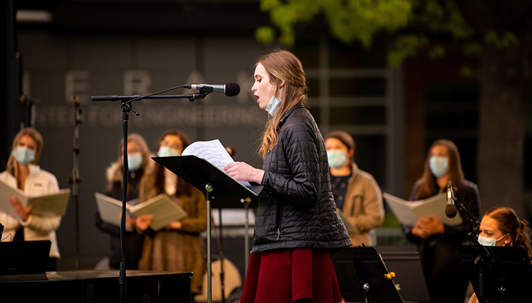 a female student leads portions of the liturgy at Mass