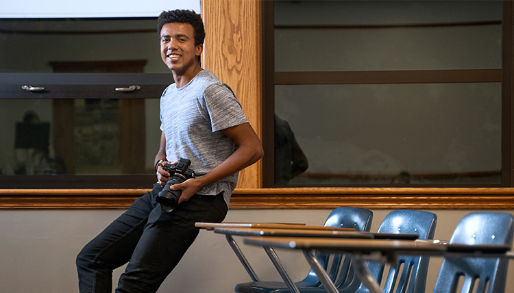 Michael Larson poses with his video camera